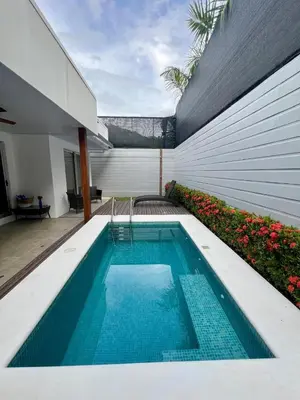 a swimming pool in the side of a house at Entire home with Private Pool - Coralita in Jaco, gated community, walking distance to Jaco Beach in Jacó