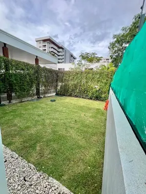 a backyard with a lawn and a fence at Entire home with Private Pool - Coralita in Jaco, gated community, walking distance to Jaco Beach in Jacó