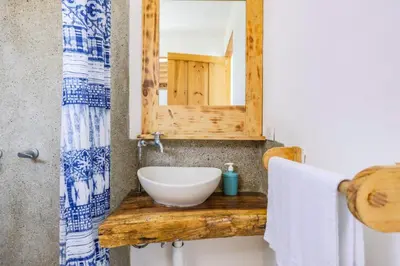 a bathroom with a sink and a mirror at Ocean View Bungalows in Pital