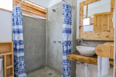 a bathroom with a sink and a mirror at Ocean View Bungalows in Pital