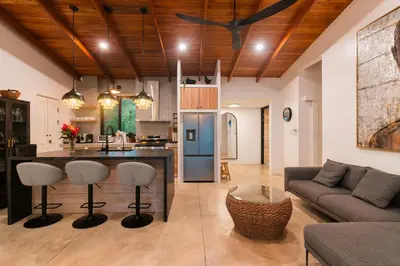 a kitchen and living room with a couch and a table at villa colibri in Nicoya