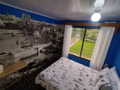 a bedroom with blue walls and a bed and a window at Casa Rincón del Monte in Monteverde Costa Rica