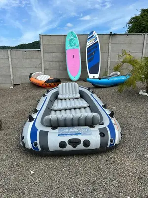 a boat and surfboards are sitting on the ground at Eco Glamping Verde, Bahia Gigante in Puntarenas
