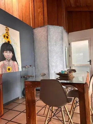 a dining room with a table and a painting on the wall at Apartamento Pequeño descanso San Ramon in San Ramón