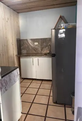 a kitchen with a stainless steel refrigerator in a room at Apartamento Pequeño descanso San Ramon in San Ramón