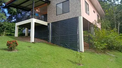 a woman on the balcony of a house at Villas Carari in Hatillo