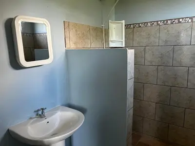 a bathroom with a sink and a mirror at Villas Carari in Hatillo