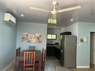 a kitchen with a table and a refrigerator at Villas Carari in Hatillo