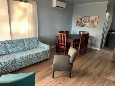 a living room with a couch and a table and chairs at Villas Carari in Hatillo
