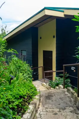 a blue house with a porch and a door at Casa Micelio in Monteverde Costa Rica