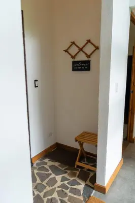 a hallway with a table and a sign on the wall at Casa Micelio in Monteverde Costa Rica