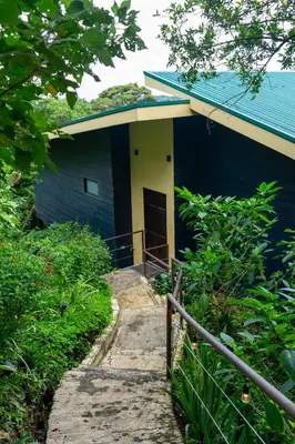 a blue house with a staircase leading to it at Casa Micelio in Monteverde Costa Rica