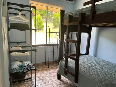 a room with four bunk beds and a window at Villas Carari 2 in Savegre