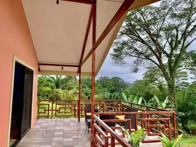 a porch with benches and a view of the forest at Villas Carari 2 in Savegre