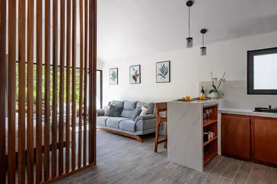a kitchen and a living room with a couch at Kalma Suite & Spa in Monteverde Costa Rica