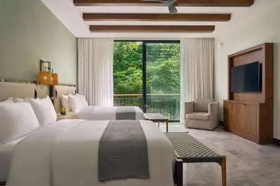 a hotel room with a large bed and a television at Nekajui Peninsula Papagayo, a Ritz-Carlton Reserve Residence in Papagayo, Guanacaste
