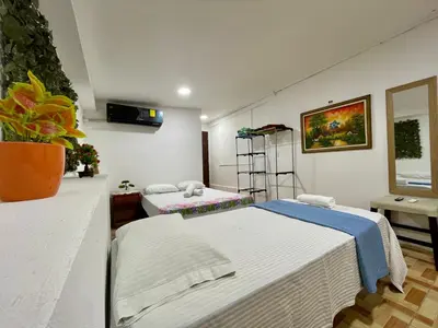 a room with two beds in a room at Apartamento el Almendro in Liberia