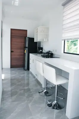 a kitchen with a white counter and a refrigerator at Blue Banana Villas in San José Pinilla