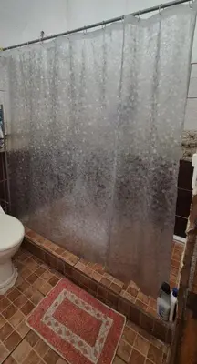 a shower with a shower curtain in a bathroom at Casa Sarita y Manuel in Curridabat