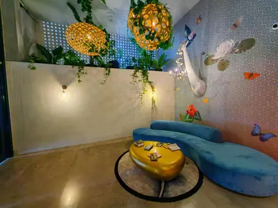 a room with two blue chairs and a table at 2811 SECRT Sabana Hermoso Estudio in San José