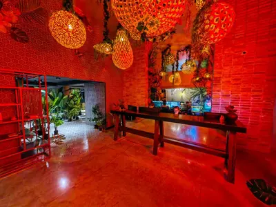 a dining room with a table and red brick walls at 2811 SECRT Sabana Hermoso Estudio in San José