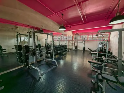 a gym with lots of tread machines and pink ceilings at 2811 SECRT Sabana Hermoso Estudio in San José