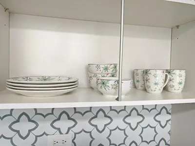 a shelf with plates and bowls on it at 2811 SECRT Sabana Hermoso Estudio in San José