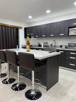 a kitchen with a large island with bar stools at Los Ángeles in Fortuna