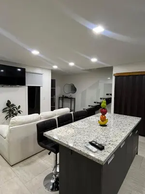 a kitchen and living room with a table and a couch at Los Ángeles in Fortuna