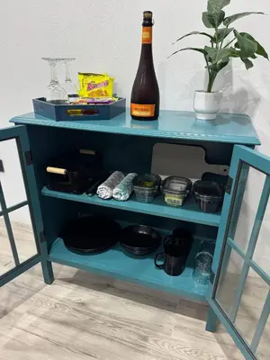 a blue shelf with a bottle of beer and a plant at Seven Paradise - Your personal rainforest in Fortuna