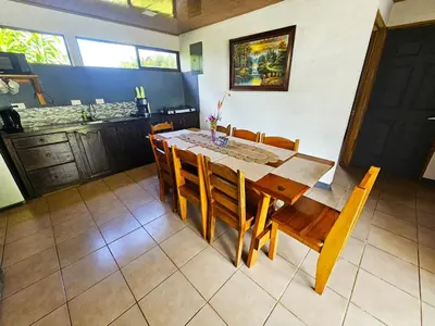 a dining room with a wooden table and chairs at Famillies Getaway - 3Bed & 2Bath in Arenal Volcano in Fortuna