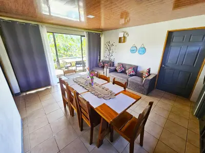 a dining room with a table and a couch at Famillies Getaway - 3Bed & 2Bath in Arenal Volcano in Fortuna