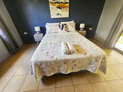 a bedroom with a bed with two slippers on it at Famillies Getaway - 3Bed & 2Bath in Arenal Volcano in Fortuna