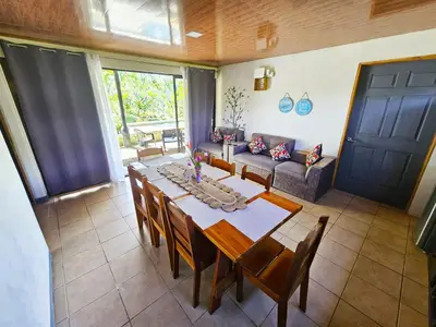 a dining room with a table and a couch at Famillies Getaway - 3Bed & 2Bath in Arenal Volcano in Fortuna