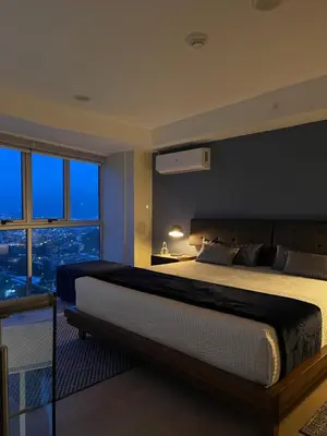 a bedroom with a large bed and a large window at Exclusive apartment in downtown Costa Rica in San José