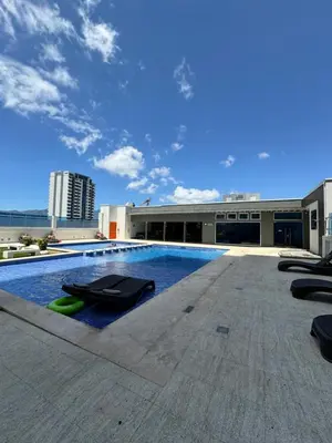 a swimming pool on the roof of a building at Penthouse in San Jose Costa Rica in San José