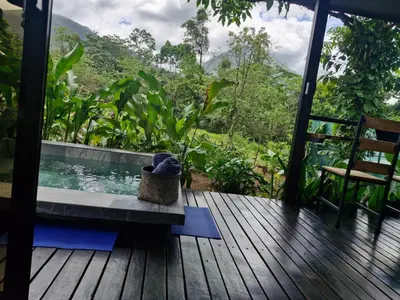 a deck with a plunge pool and a chair on a house at Pantala Villa in Fortuna