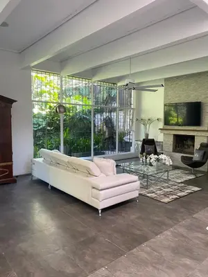 a living room with a white couch and a glass table at Gitana Hermosa in San Rafael