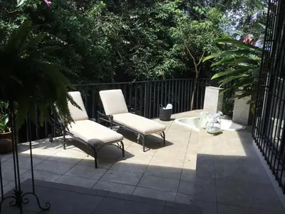 two chairs and a tub on a patio at Gitana Hermosa in San Rafael