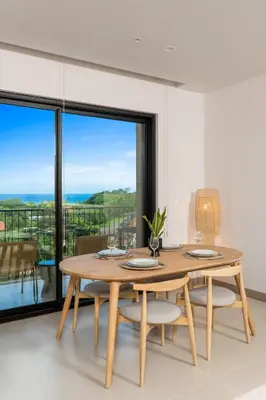 a dining room with a table and chairs with a view at Kokito at Naumi, Ocean Views & Beach Club in Coco