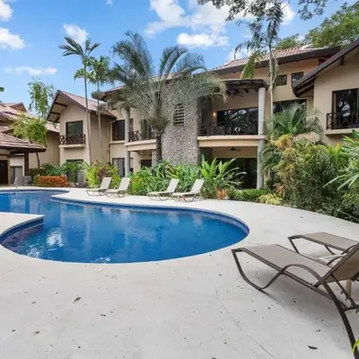 Modern Island-Themed Condo with Floor-to-Ceiling Windows & Garden and Pool Views Within Walking Distance of the Beach