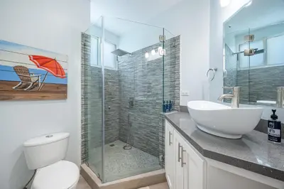 a bathroom with a sink and a toilet and a shower at Twin Dolphins 2A in Playa Flamingo