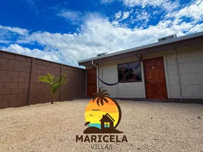 a sign in front of a building with a house at Villas Maricela Guanacaste in Chorro