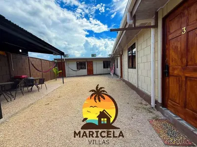 a sign on the side of a building with a sunset at Villas Maricela Guanacaste in Chorro