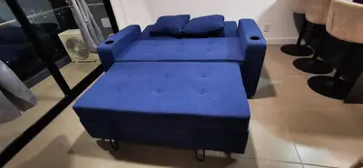 a blue couch with pillows sitting in a room at Apartamento Bo Escalante 803 in San José