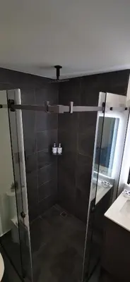 a bathroom with a shower with a glass door at Apartamento Bo Escalante 803 in San José
