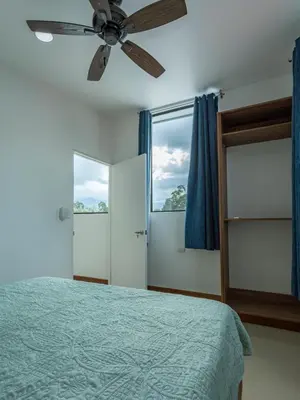 a bedroom with a bed and a ceiling fan at Sweet Dreams the Arenal in Fortuna