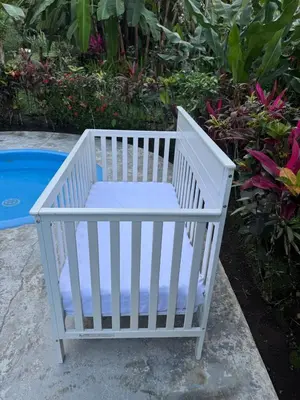 a white crib with a pillow in a garden at Hanging Rustic Cabin with Balcony and terrace #4 in Fortuna