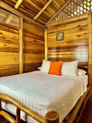 a wooden cabin with a bed in a room at Hanging Rustic Cabin with Balcony and terrace #4 in Fortuna