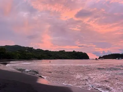 a view of a beach with a sunset at Serena Suites L2 Playas del Coco in Coco